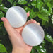 Elegant selenite sphere held in hand, showcasing its glossy surface and serene aura.