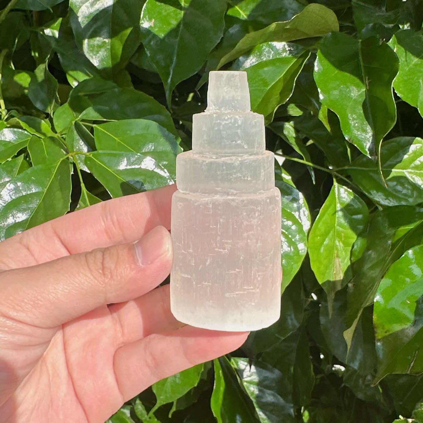 Side view of the Selenite Tower highlighting its smooth texture and translucent glow, perfect for enhancing positive energy.