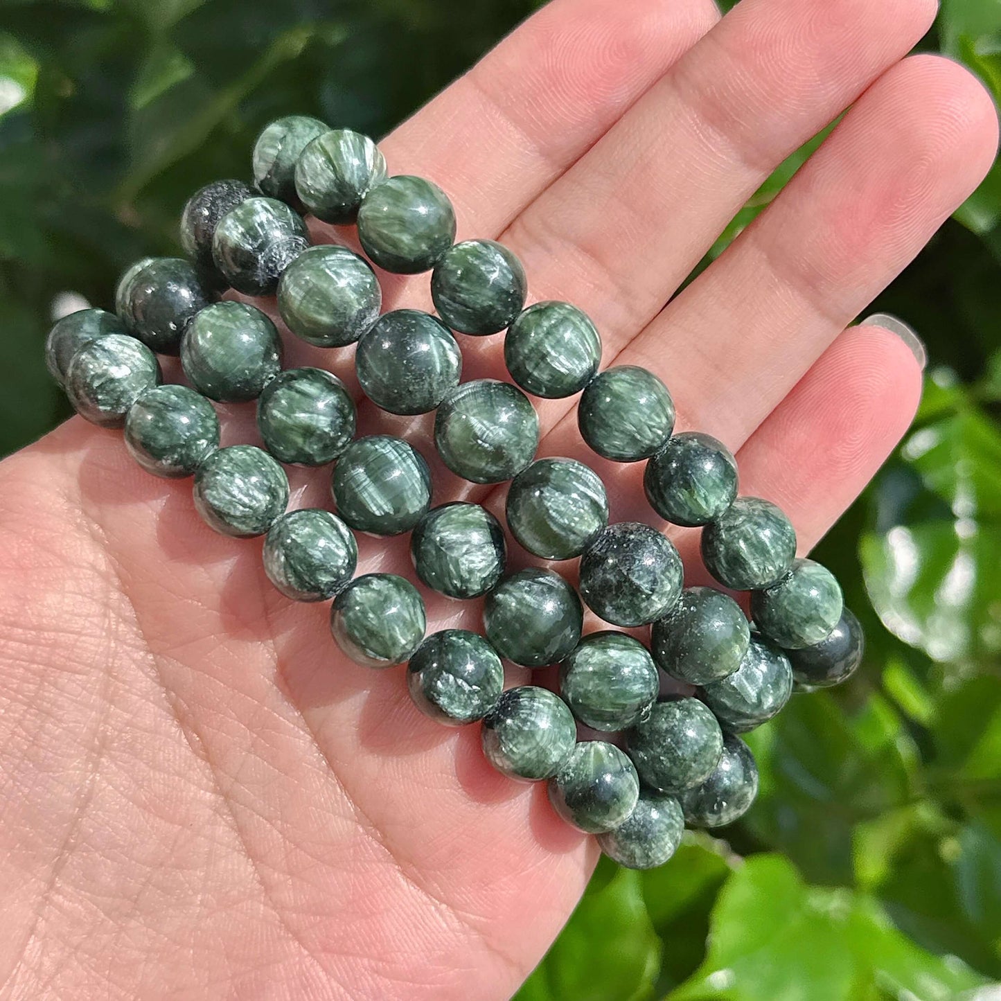 Seraphinite gemstone bracelet worn on wrist, showing natural beauty and healing properties.