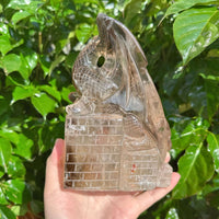 Profile view of Smoky Quartz Dragon Carving showing intricate texture.