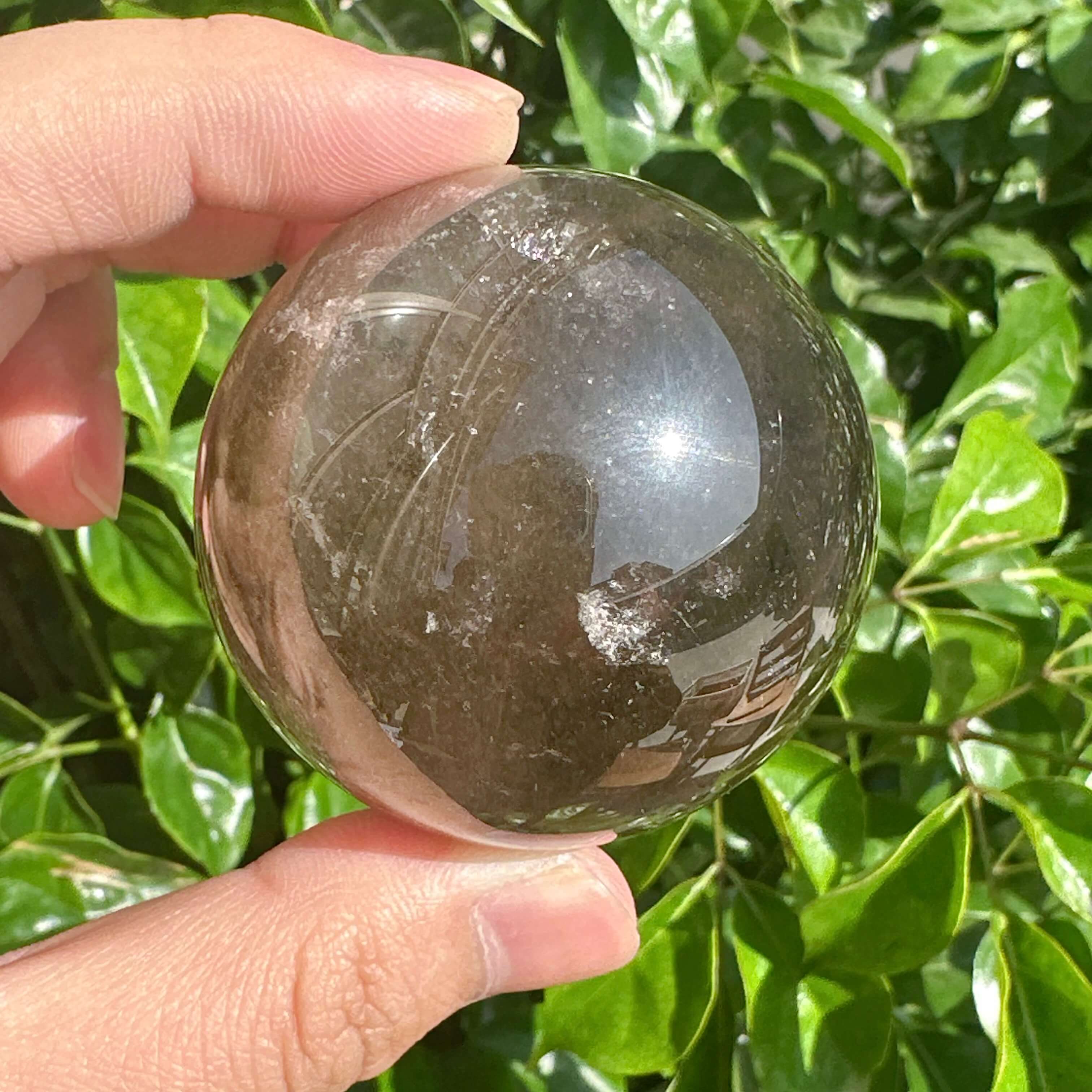 Smoky Quartz Sphere emphasizing the crystal’s natural beauty and grounding properties, ideal for personal energy balancing.