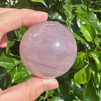 A set of Star Rose Quartz Spheres with smooth surfaces and stunning star-shaped reflections, radiating peaceful energy.