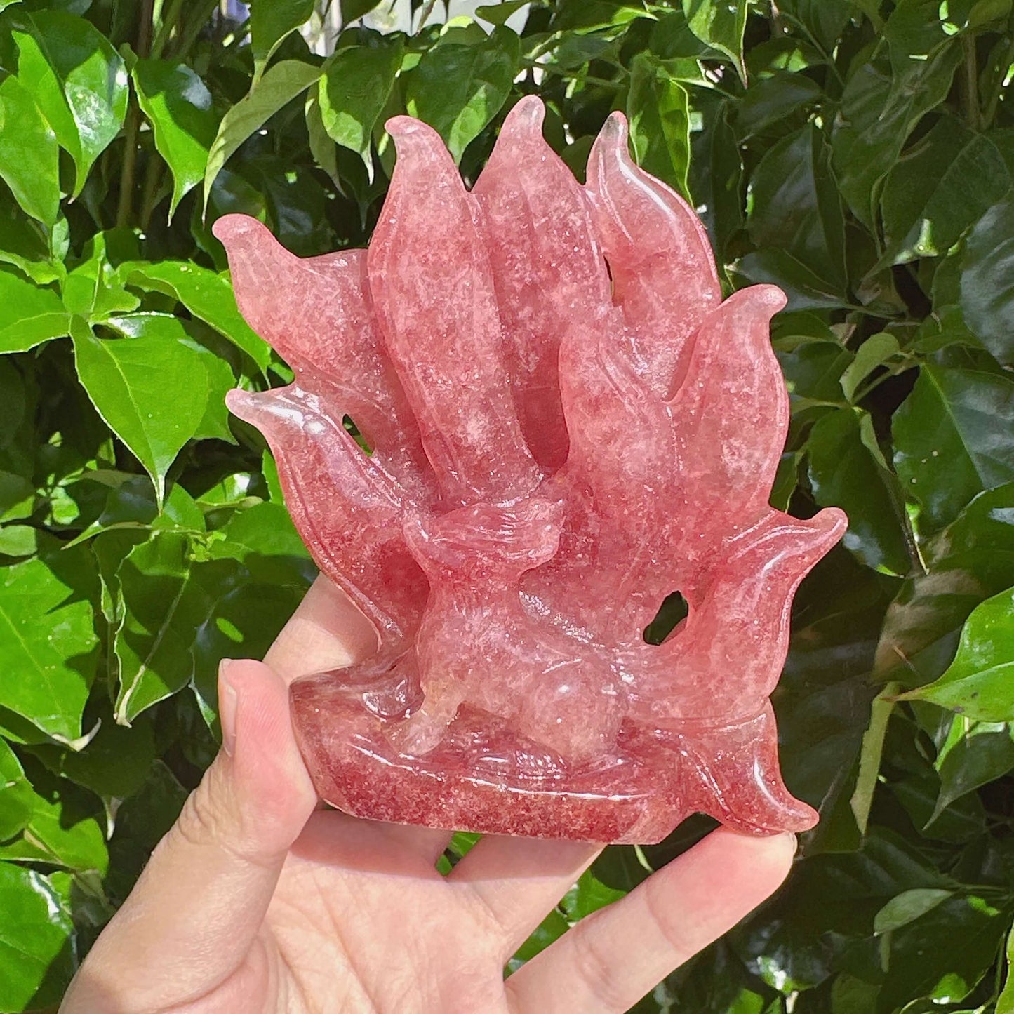 Side view of the Strawberry Quartz Nine-Tailed Fox Carving highlighting the mystical fox figure and flowing tail.