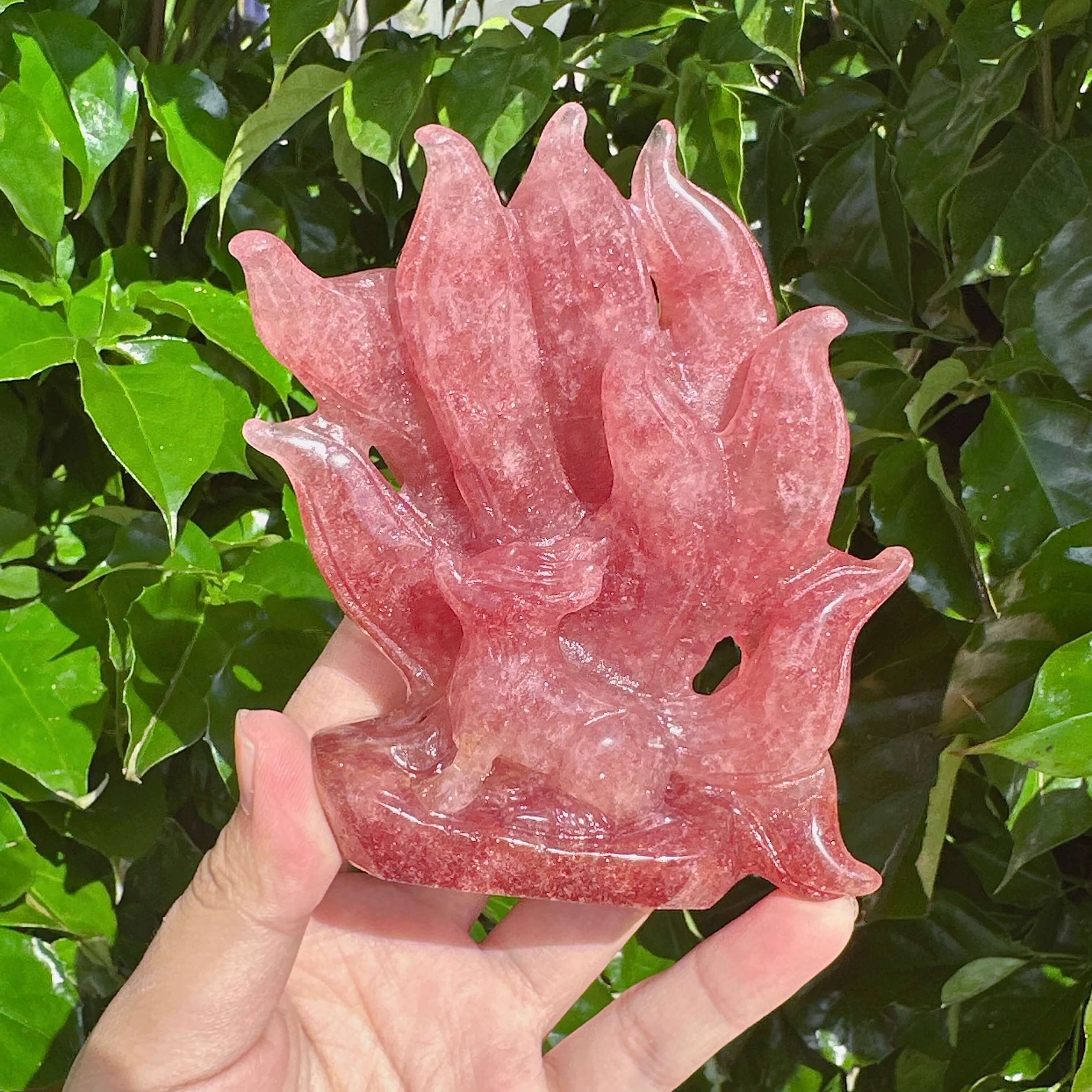 Side view of the Strawberry Quartz Nine-Tailed Fox Carving highlighting the mystical fox figure and flowing tail.