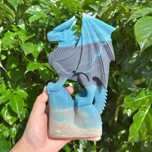 Angled view of Trolleite Dragon Carving, emphasizing the strong presence of the dragon with its powerful stance and detailed features.