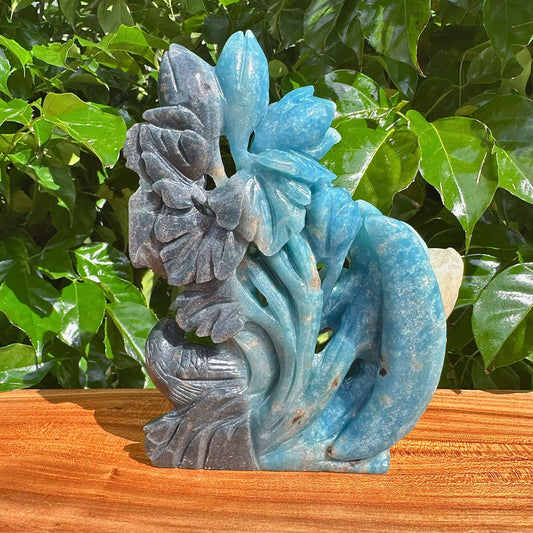 Close-up view of the Trolleite Flower and Bird Carving, focusing on the exquisite detail and natural hues of the flower and bird design.