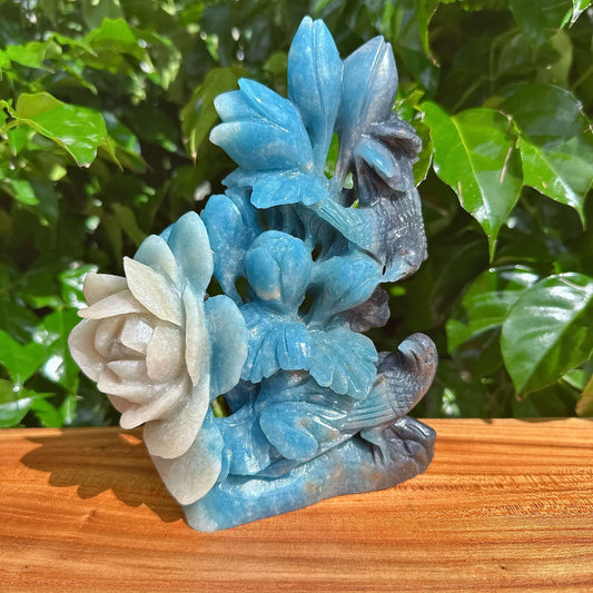 Detailed view of the Trolleite Flower and Bird Carving, showcasing the fine craftsmanship and natural color variations of the stone.