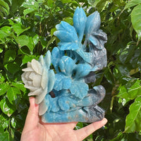 Side view of the Trolleite Flower and Bird Carving, highlighting the graceful bird and flower elements crafted with fine Trolleite crystal.