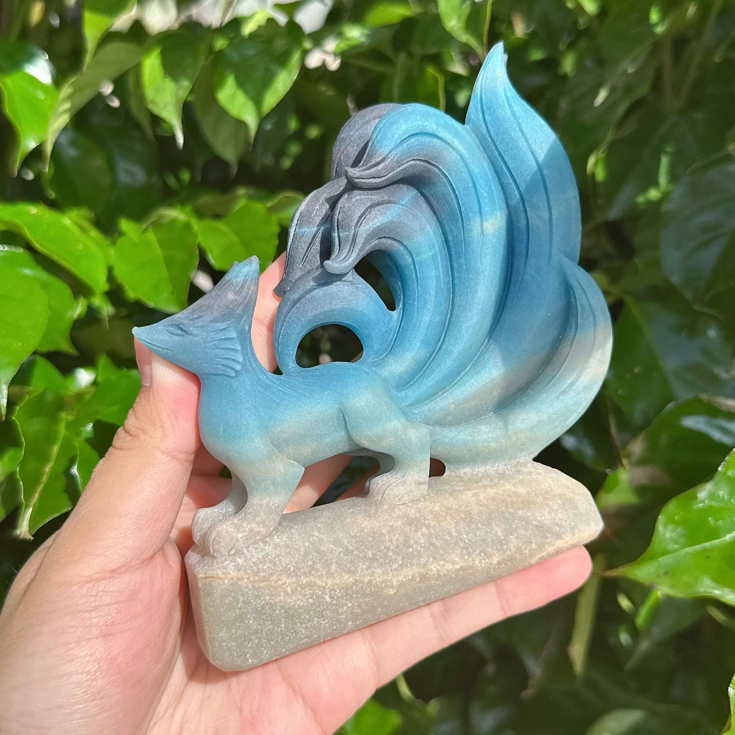 Detailed view of Trolleite Nine-Tailed Fox Carving with flowing tails and sharp features