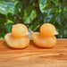 Yellow Calcite Duck Carving displaying a smooth, glossy finish, and warm golden tones.