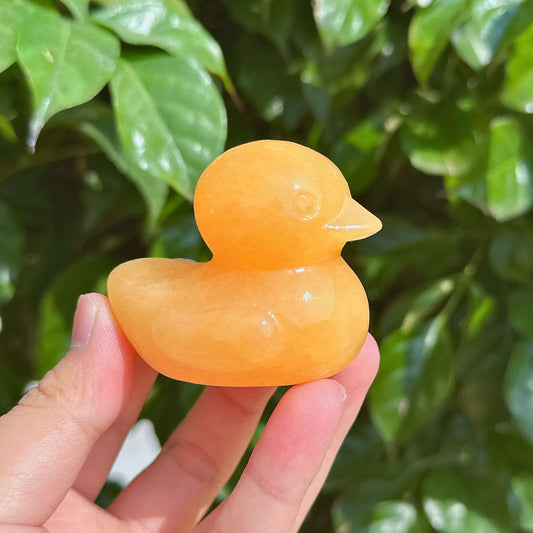Side view of a Yellow Calcite Duck Carving, showcasing its smooth texture and vibrant color.
